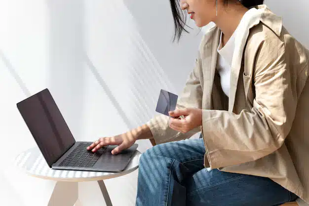 Asian woman online shopping using her laptop