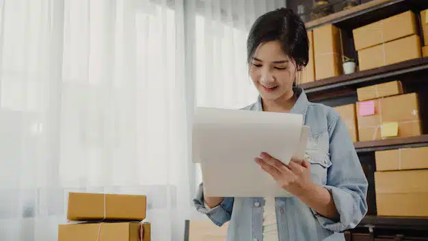 Beautiful smart asian young entrepreneur business woman owner sme checking product stock