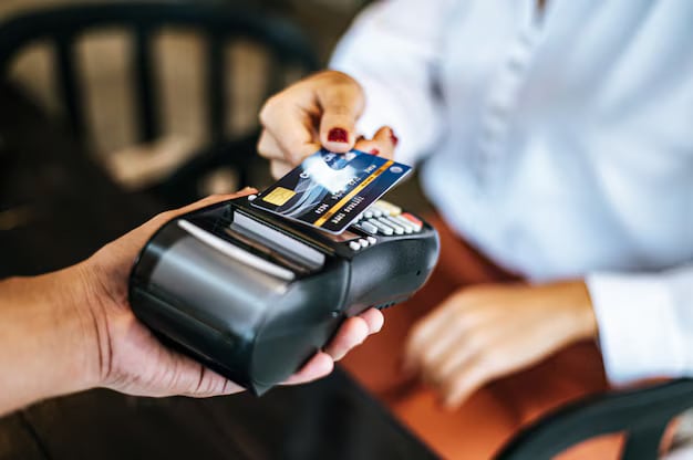 Close up image woman paying with credit card cafe