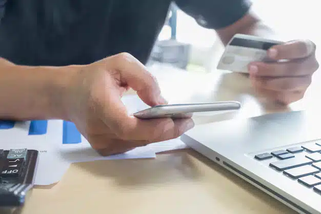 Man holding mobile phone credit card laptop online shopping