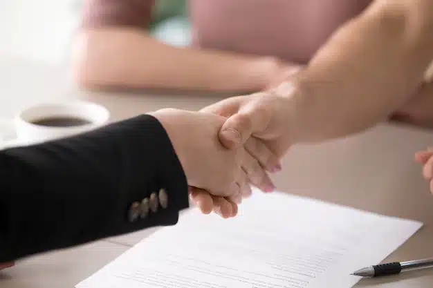 Man woman handshaking after signing documents successful deal closeup