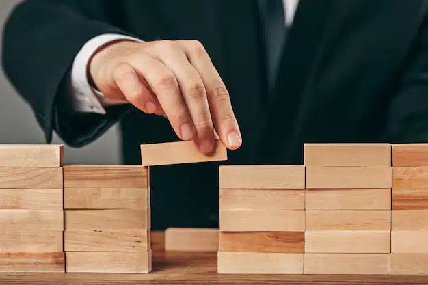 Man wooden cubes table management concept