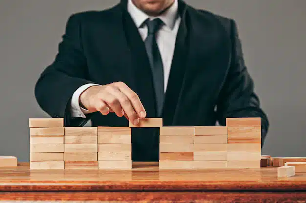 Man wooden cubes table management concept