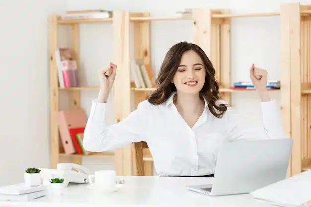 Portrait smiling pretty young business woman sitting workplace
