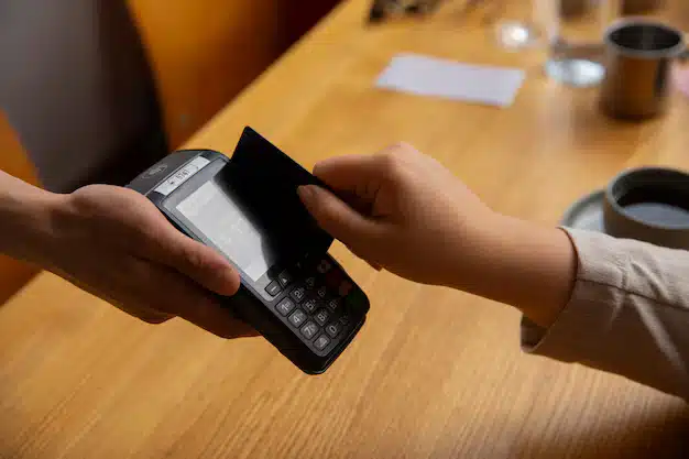 Side view customer paying with nfc device 23