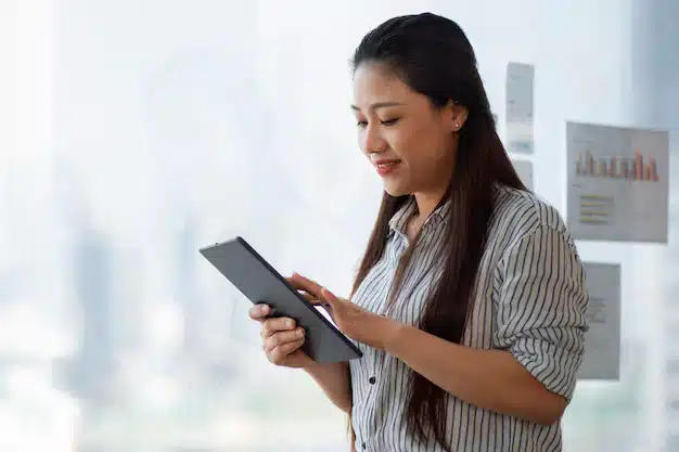 Side view smiley woman holding tablet 23