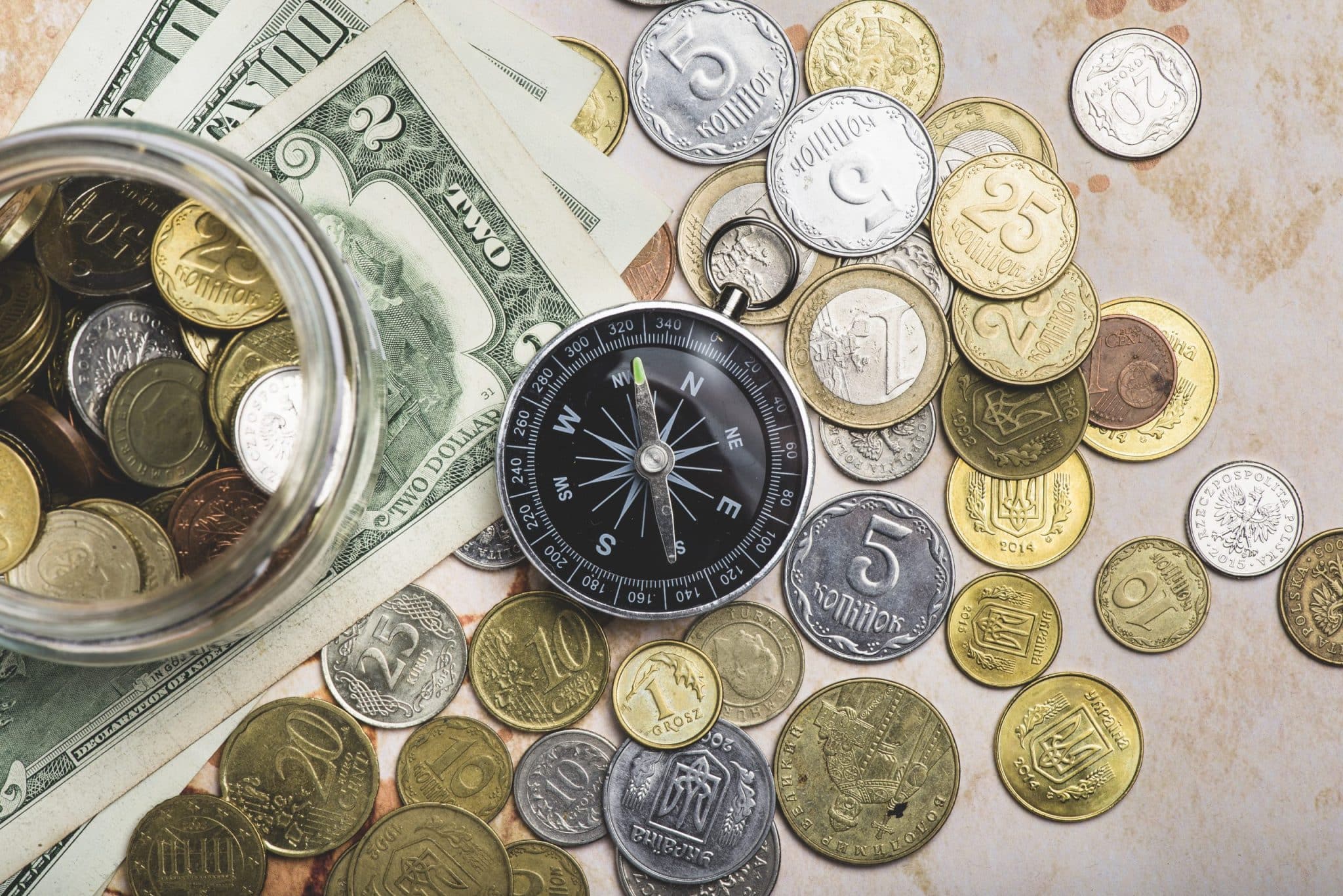 Compass with coins banknotes