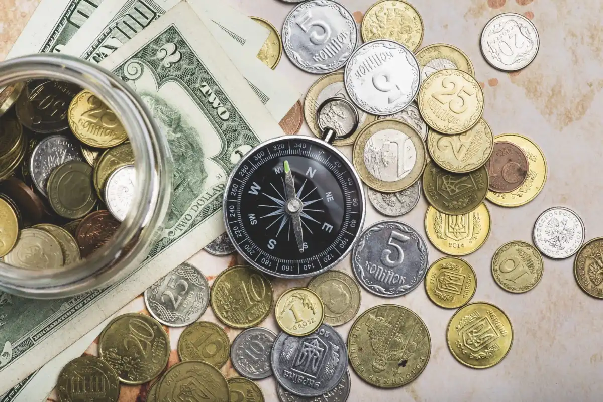 Compass with coins banknotes
